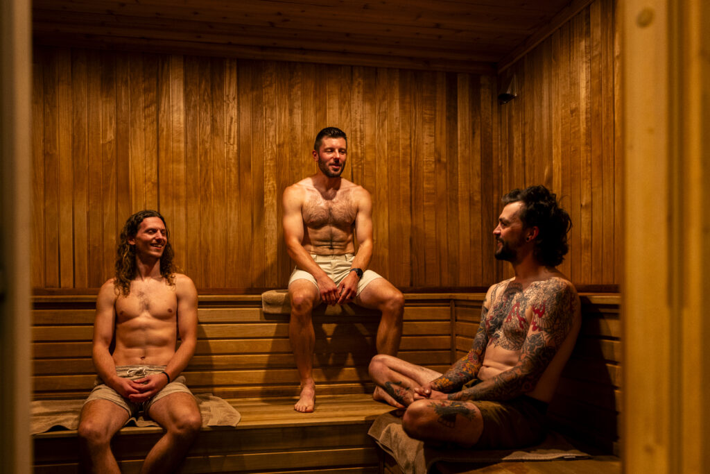 Three people relaxing in the sauna at the Lounge @ the Bunker