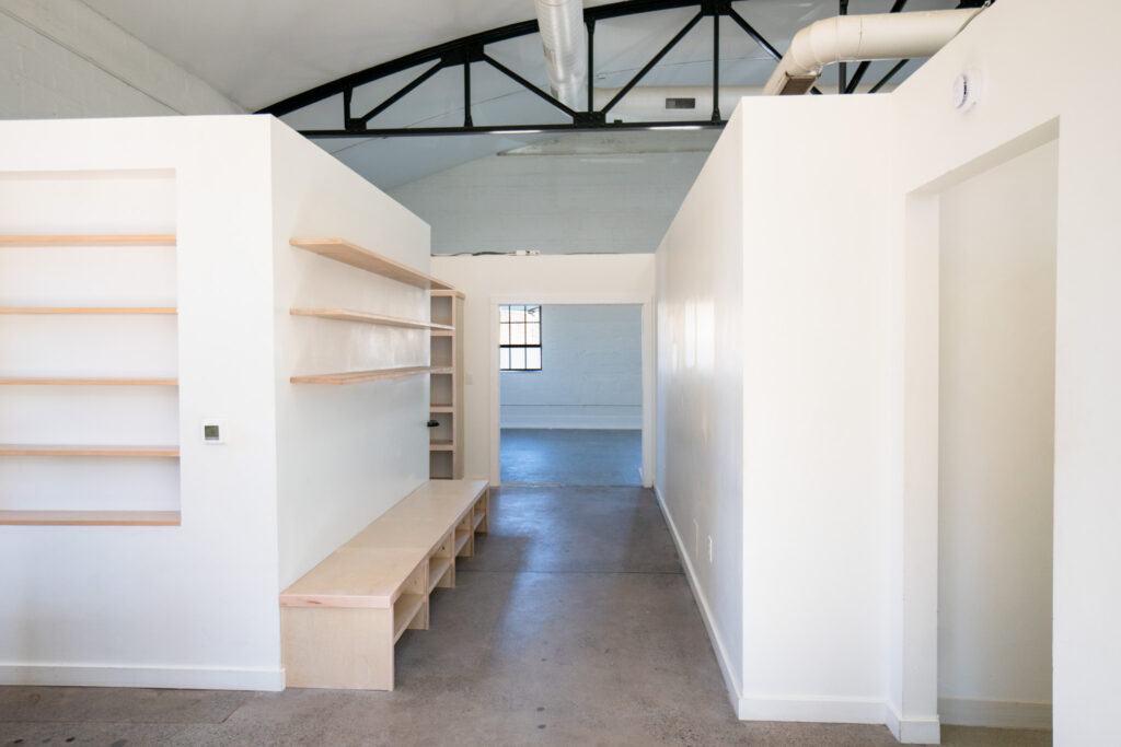 Changing area at the Bathhouse with built-in cubbies and a wooden bench