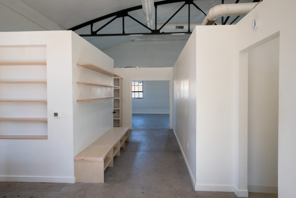 Changing area at the Bathhouse with built-in cubbies and a wooden bench